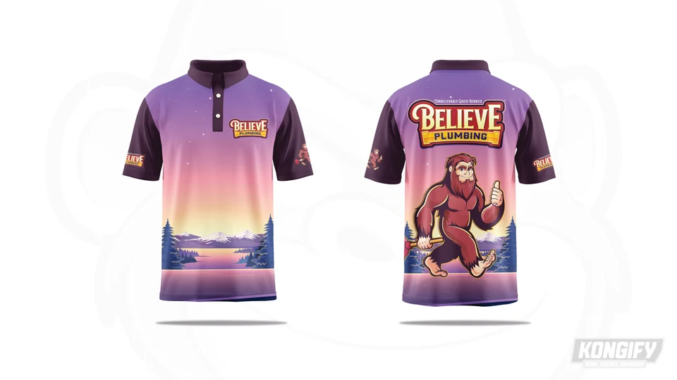 Believe Plumbing polo with a purple and pink sky, mountain lake at the hem, chest logo, and large Bigfoot on the back.